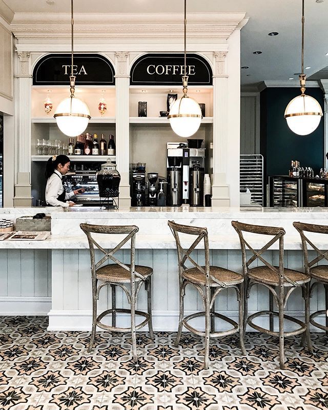 Elegant Cafe Design with Marble Bar, Inviting Ambiance, and Rustic-Chic Seating