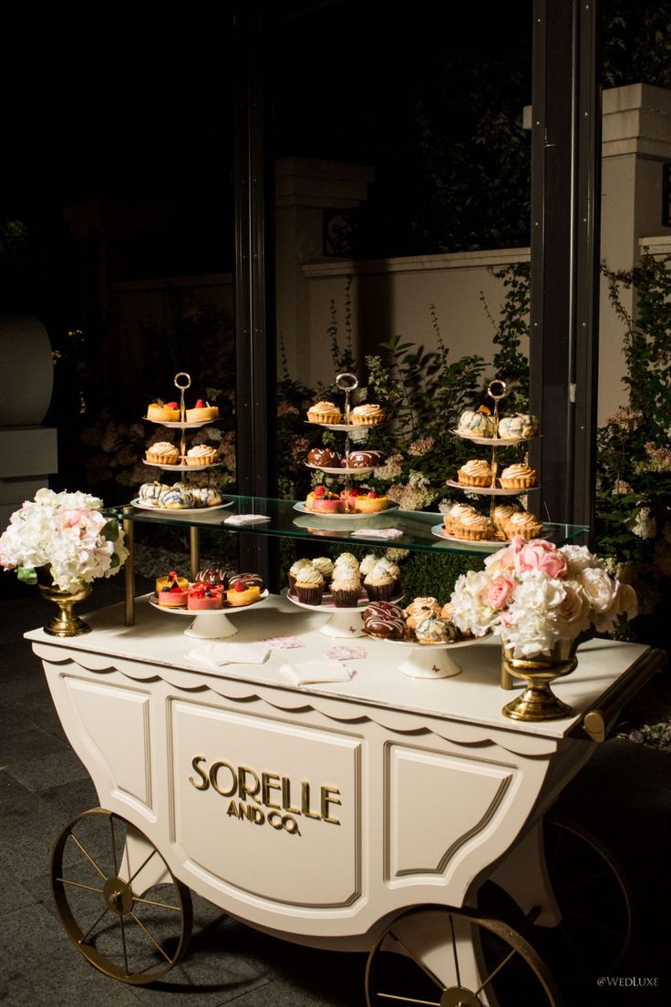 Elegant Cafe Design: A Sophisticated Dessert Display Amidst Lush Greenery