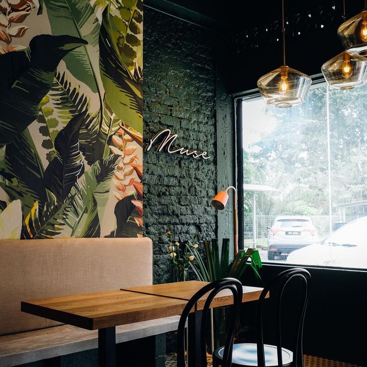 Inviting Cafe Design Blends Lush Greenery with Warm Wood Elements for a Refreshing Atmosphere