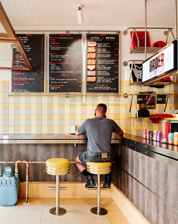 Modern Cafe Design: A Vibrant Aesthetic with Colorful Tiled Walls and Inviting Atmosphere