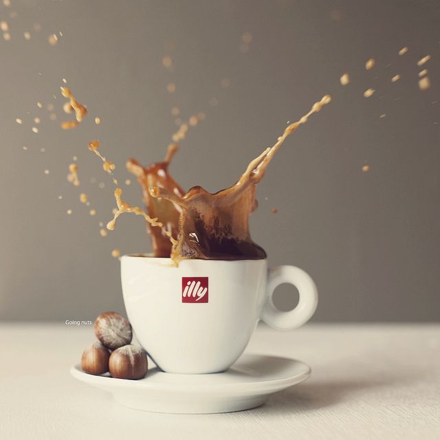 Dynamic Cafe Moment: Splashing Coffee and Hazelnuts Captured in Vibrant Energy