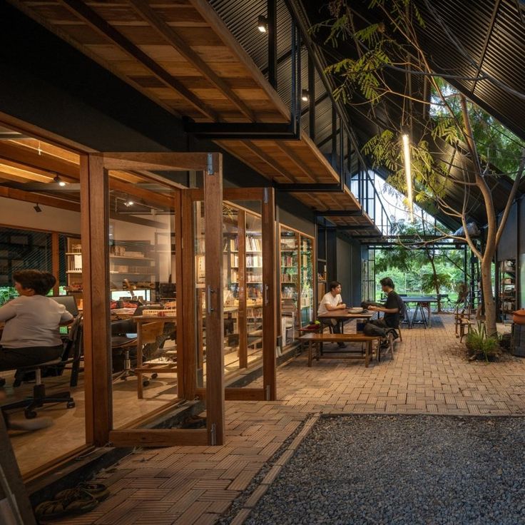 Harmonious Cafe Design Merges Indoor Comfort with Lush Outdoor Elements