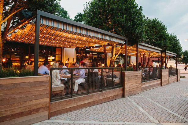 Modern Outdoor Cafe Seating with Cozy Pergola and Inviting Atmosphere