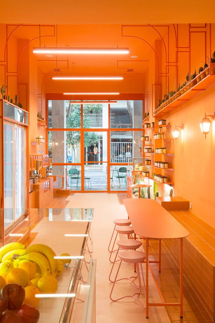 Vibrant Orange Cafe Design Fuses Modernity and Nature for a Welcoming Atmosphere