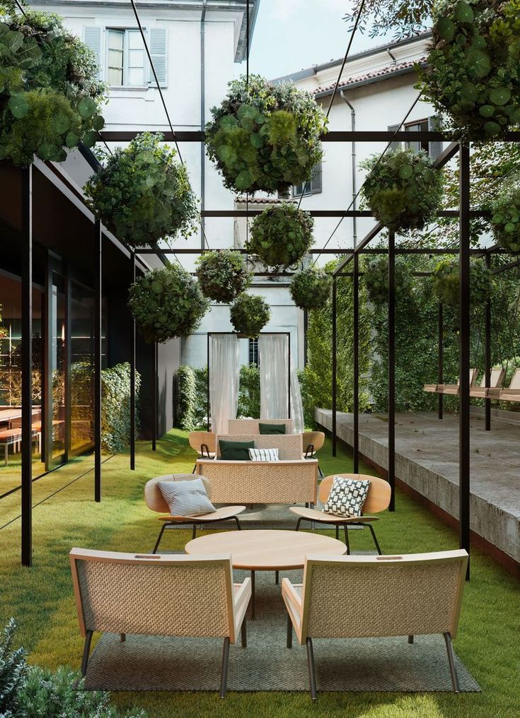 Modern Cafe Design Features Inviting Outdoor Space with Lush Canopy and Comfortable Lounge Seating