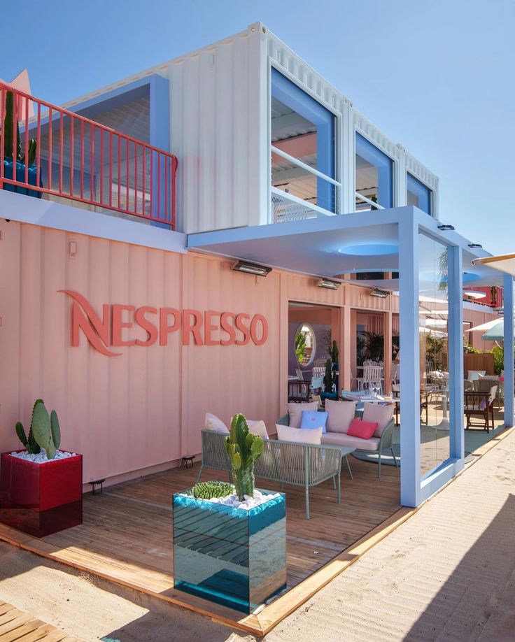 Contemporary Cafe Design: Vibrant Aesthetic and Inviting Ambiance with Shipping Containers and Natural Elements