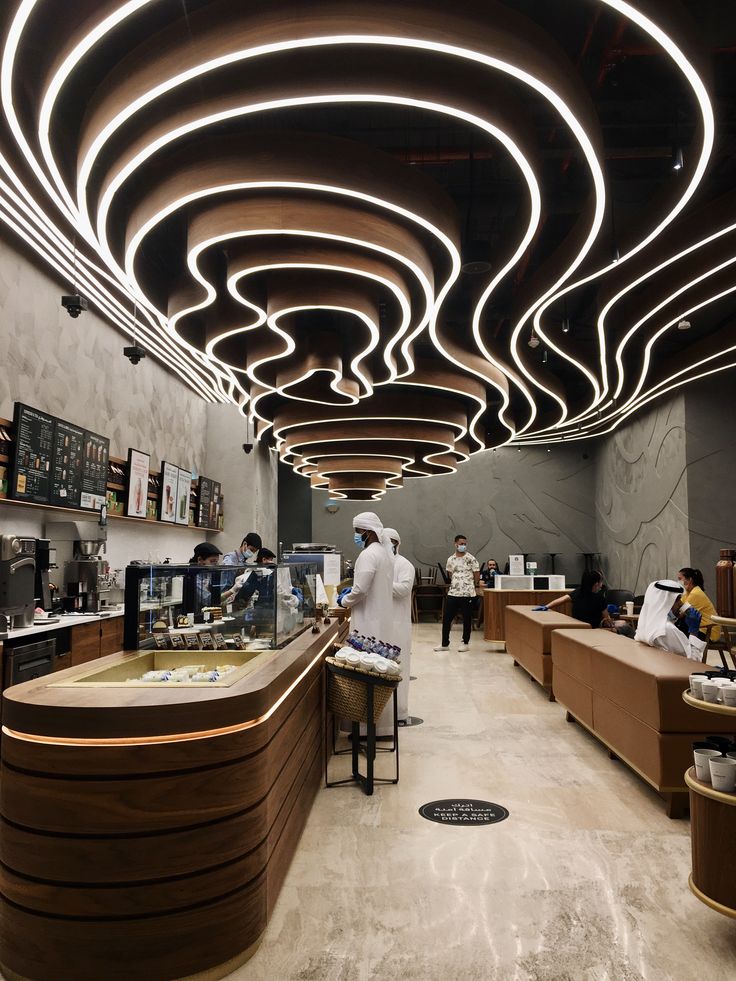 Inviting Cafe Design: Dynamic Ceiling, Natural Elements, and Comfortable Seating Foster a Relaxed Atmosphere