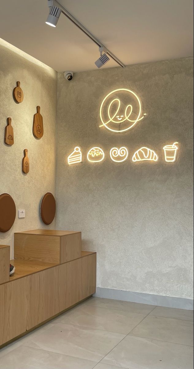 Modern Minimalist Cafe Design: Inviting Ambiance with Textured Walls and Stylish Neon Art