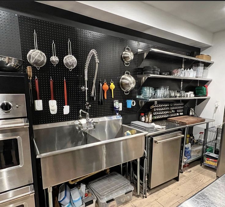 Sleek, Functional Cafe Design: A Minimalist Kitchen with Modern Stainless Steel Elements and Organized Storage Solutions