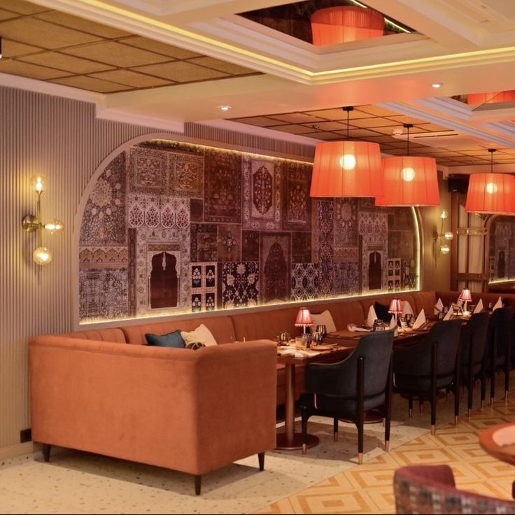 Inviting Cafe Interior Blends Earthy Tones, Cultural Mural, and Cozy Atmosphere for Relaxation and Socialization