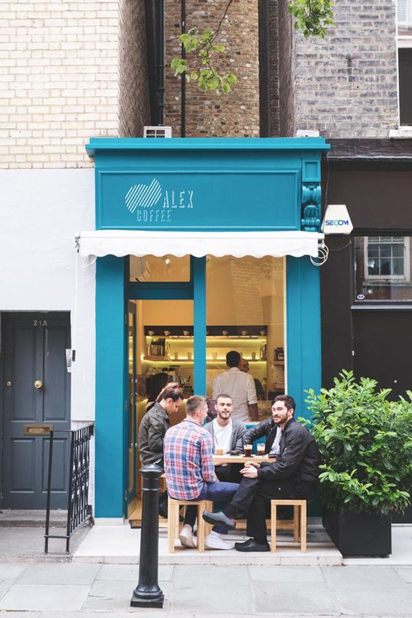 Charming Cafe with Turquoise Facade and Inviting Outdoor Seating