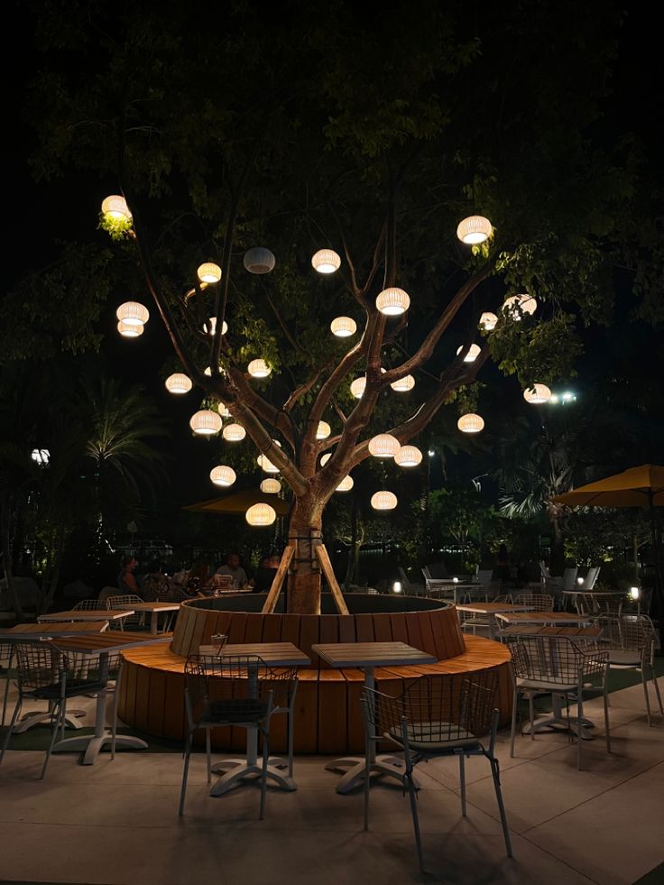 Cozy Cafe Design with Illuminated Tree and Communal Seating Enhances Social Interaction