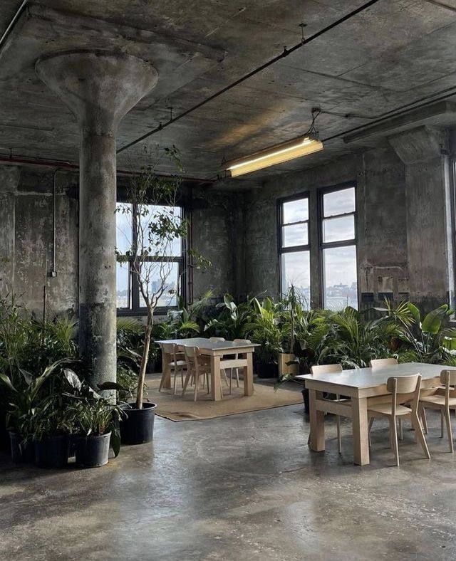 Inviting Industrial Cafe Design Blends Minimalism and Nature for a Relaxed Urban Retreat